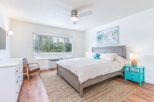 a bedroom with a bed and a desk and a chair at Emmalani Court 423 in Princeville