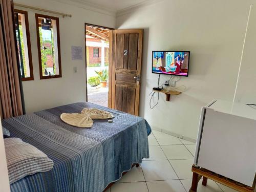 a room with a bed with a towel on it at Pousada Casa Grande in Barreirinhas