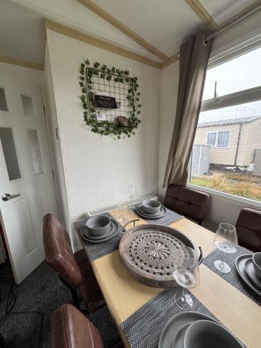 a dining room table with a wreath on the wall at 148 Port Haverigg in Millom