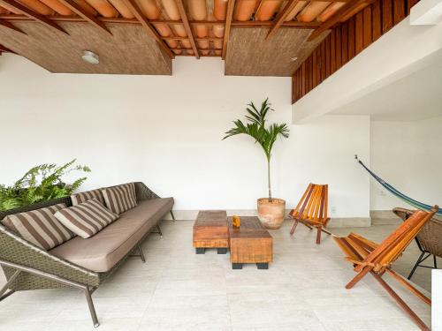 a living room with a couch and a table at Hotel Premium Recanto da Passagem in Cabo Frio