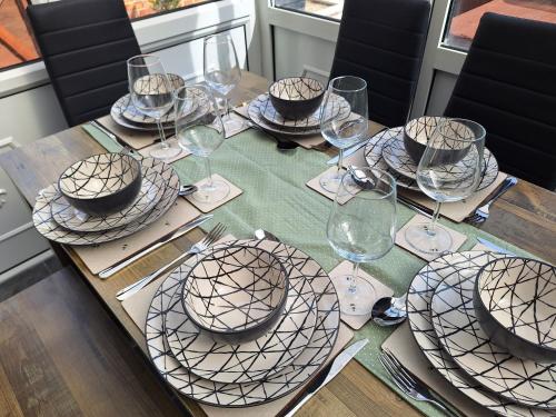 a table with plates and wine glasses on it at Fieldside House in Scarborough
