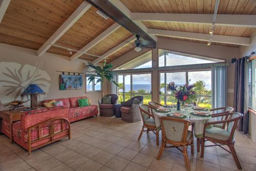 a living room with a table and chairs and a couch at Hale Hamakua in Papaaloa