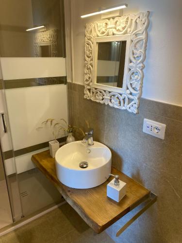 a bathroom with a white sink and a mirror at Seaside - A Due Passi Dal Mare in Fano