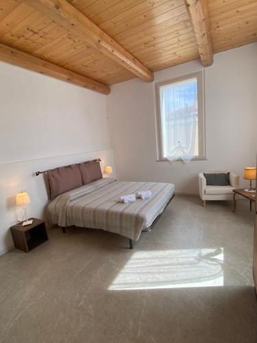 a bedroom with a large bed and a window at Seaside - A Due Passi Dal Mare in Fano