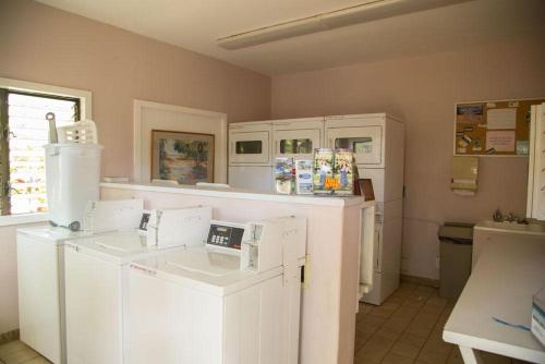 a kitchen with white appliances in a room at Lae Nani 434 in Kapaa