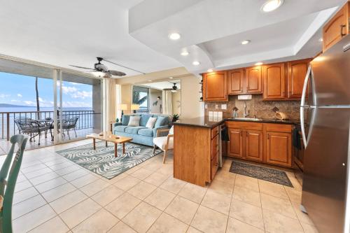 a kitchen and living room with a view of the ocean at Maalaea Kai 315 in Wailuku