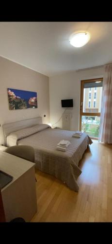 a bedroom with a large bed and a large window at AF Apartments FaraOne in Bari