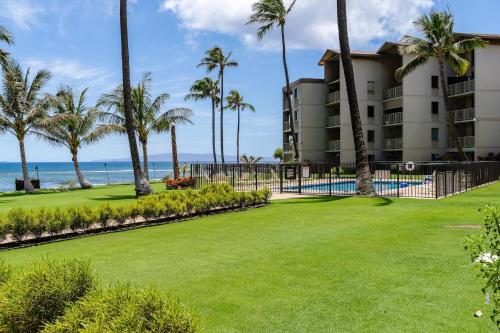 a view of a resort with a pool and palm trees at Maalaea Kai 315 in Wailuku