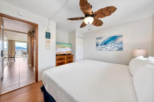 a bedroom with a bed and a ceiling fan at Maalaea Kai 315 in Wailuku