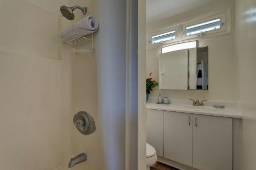 a bathroom with a toilet and a sink and a mirror at Hilo Hale Kaumana in Hilo
