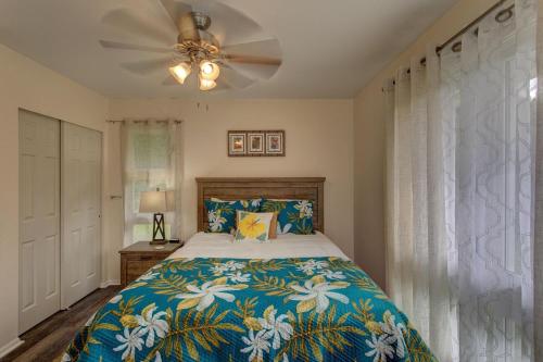 a bedroom with a bed and a ceiling fan at Hilo Hale Kaumana in Hilo