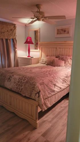 a bedroom with a large bed with a red lamp at 210 Worchester St #405 in Ocean City