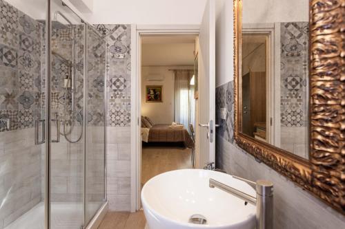 a bathroom with a tub and a sink and a shower at Mondello House Eraclea in Mondello