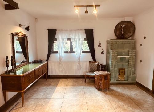 a living room with a dresser and a window at Casa Pisica Noastra in Breaza