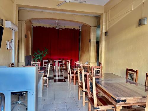 a dining room with a long table and chairs at Latanier Beach Hotel in Grand Baie