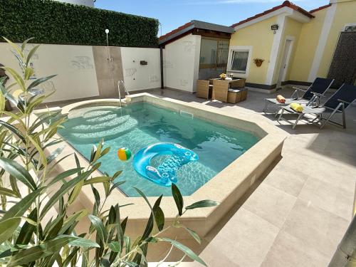 a swimming pool in the middle of a backyard at Poolside Studio in Fažana