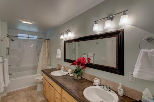 a bathroom with two sinks and a large mirror at Fern Forest Hale in Volcano