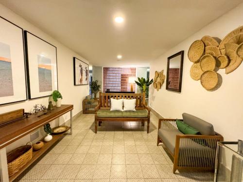 a living room with a couch and a chair at Hotel Premium Recanto da Passagem in Cabo Frio