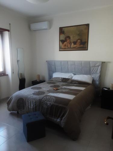 a bedroom with a large bed in a room at B&B Il viaggio in Borghesiana 