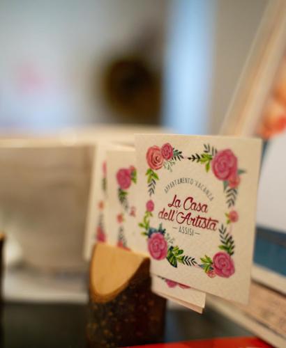 a card that says in class call catcher on a table at La casa dell’artista in Assisi