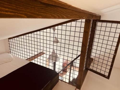 a cage with a bed in a room at Casa Pisica Noastra in Breaza