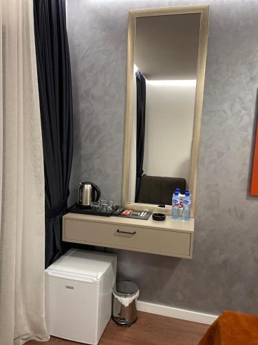 a dresser with a mirror on a wall at Lolo Luxury rooms & suites in Budva