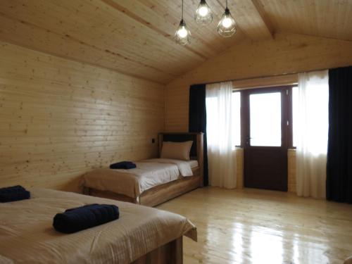 a room with two beds and a window in it at Cottage nikolozi2 in Arsha