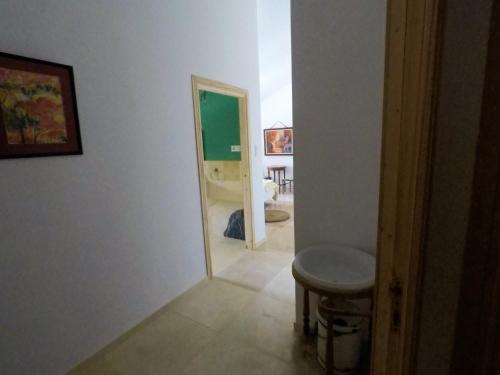 a hallway with a stool and a room with a bathroom at Castell Granadella in L'Ampolla