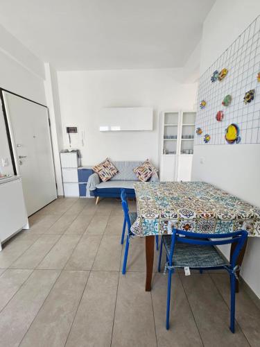 a dining room with a table and a bench at Il Balcone sul Conero in Marcelli