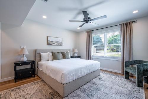 a bedroom with a bed and a ceiling fan at New Remodel! 4BR Near DT Cartersville & Major Hwys in Cartersville