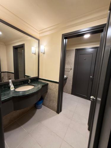 a bathroom with a sink and a mirror at The Times Square By Family Suites in Kuala Lumpur