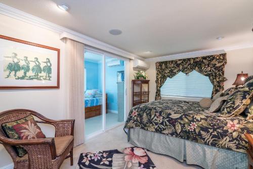 a bedroom with a king sized bed and a window at Kailua Beachside in Kailua