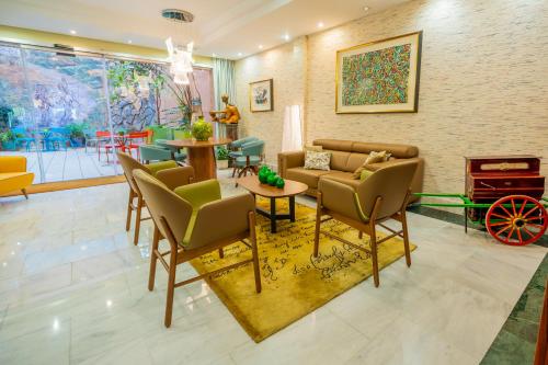 a living room with a couch and chairs and a table at Hotel Sancho in Madrid