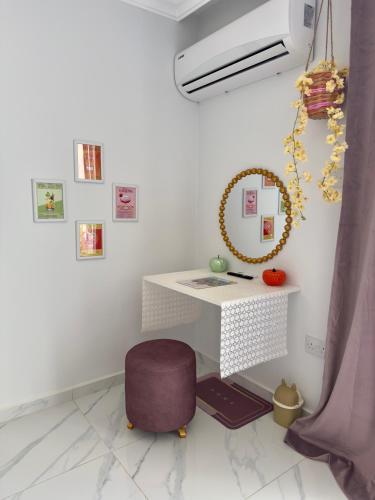 a desk with a purple chair and a mirror at Lavender Homes Iskele - Cosy Studio with Pool in Famagusta