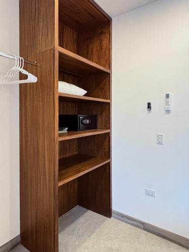 a book shelf with a microwave in a room at 2 Casas and Pool- Walk to Beach, Great for Groups in El Pescadero
