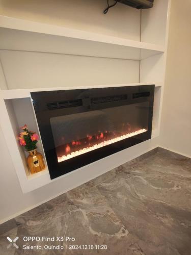 a fireplace in a wall with a fire in it at Aparta Hotel Boutique Salento in Salento