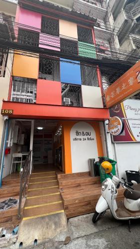 a building with a scooter parked in front of it at Golden mango home Youth hostel 金芒果之家青年旅舍 in Bangkok