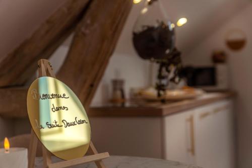a wooden chair with a sign that says something lives in the kitchen at Les Suites C&S in Aufferville