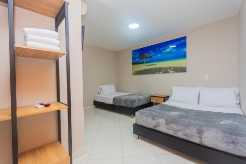 a small room with two beds and a bunk bed at Hotel Tropical San Jeronimo in San Jerónimo
