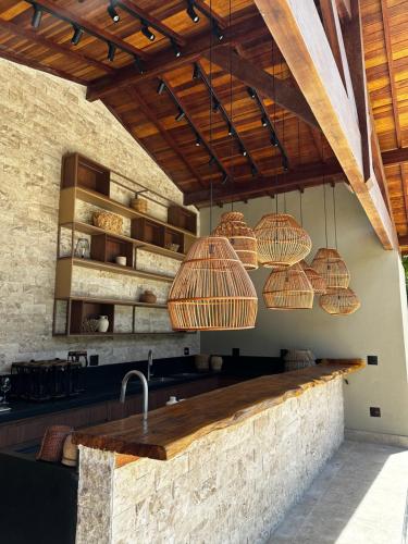 a kitchen with baskets hanging from the ceiling at Pousada Villa Dois Amores in Lindóia