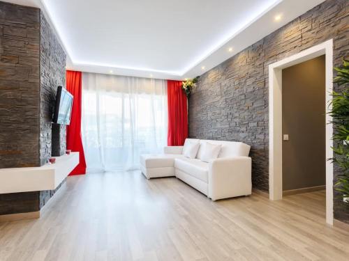 - un salon avec un canapé blanc et un mur en briques dans l'établissement Maison en Villefranche pour les tourists, à Villefranche-sur-Mer