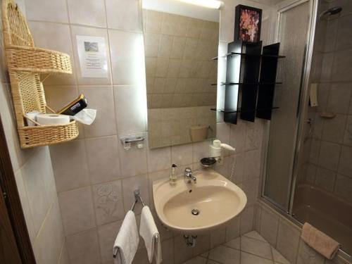 a bathroom with a sink and a shower at Hotel Bischof in Schmallenberg