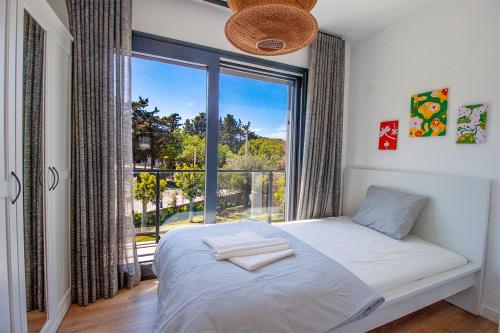 a bedroom with a bed and a large window at Villa Casa LUZ in Bodrum City