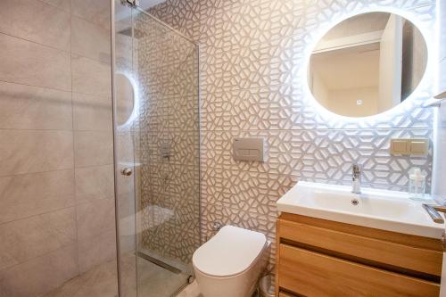 a bathroom with a shower and a toilet and a sink at Villa Casa LUZ in Bodrum City