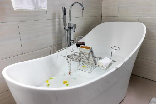 a bath tub with a faucet in a bathroom at Coastal Escape in Riviera Tower Isle Beach Neaby in St Mary