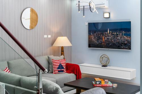 a living room with a couch and a tv at Coastal Escape in Riviera Tower Isle Beach Neaby in St Mary