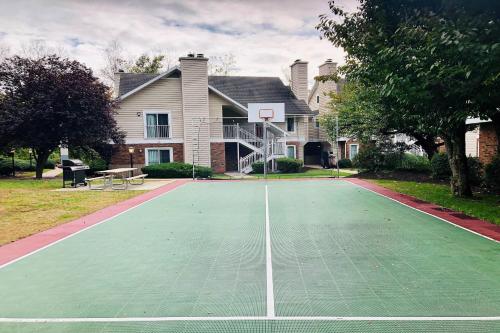 a basketball court in front of a house at Residence Inn Hartford Windsor in Windsor