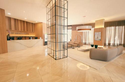 a living room and dining room with a lobby at TRYP By Wyndham Ribeirão Preto in Ribeirão Preto