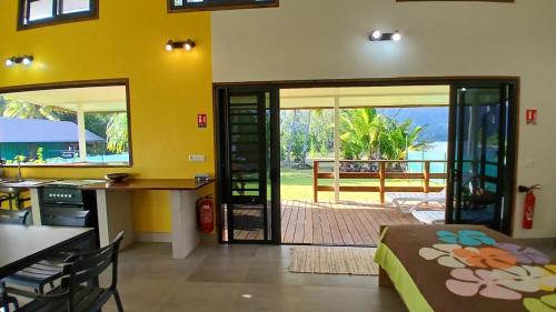 a room with a door leading to a patio at Tahiti Iti - Fare Pihiti Spot in Paui