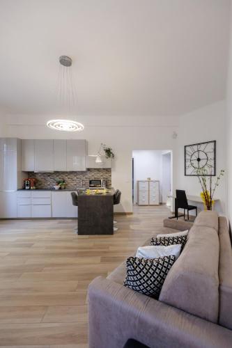 a living room with a couch and a kitchen at Genoa Lux Apartments with parking in Genova